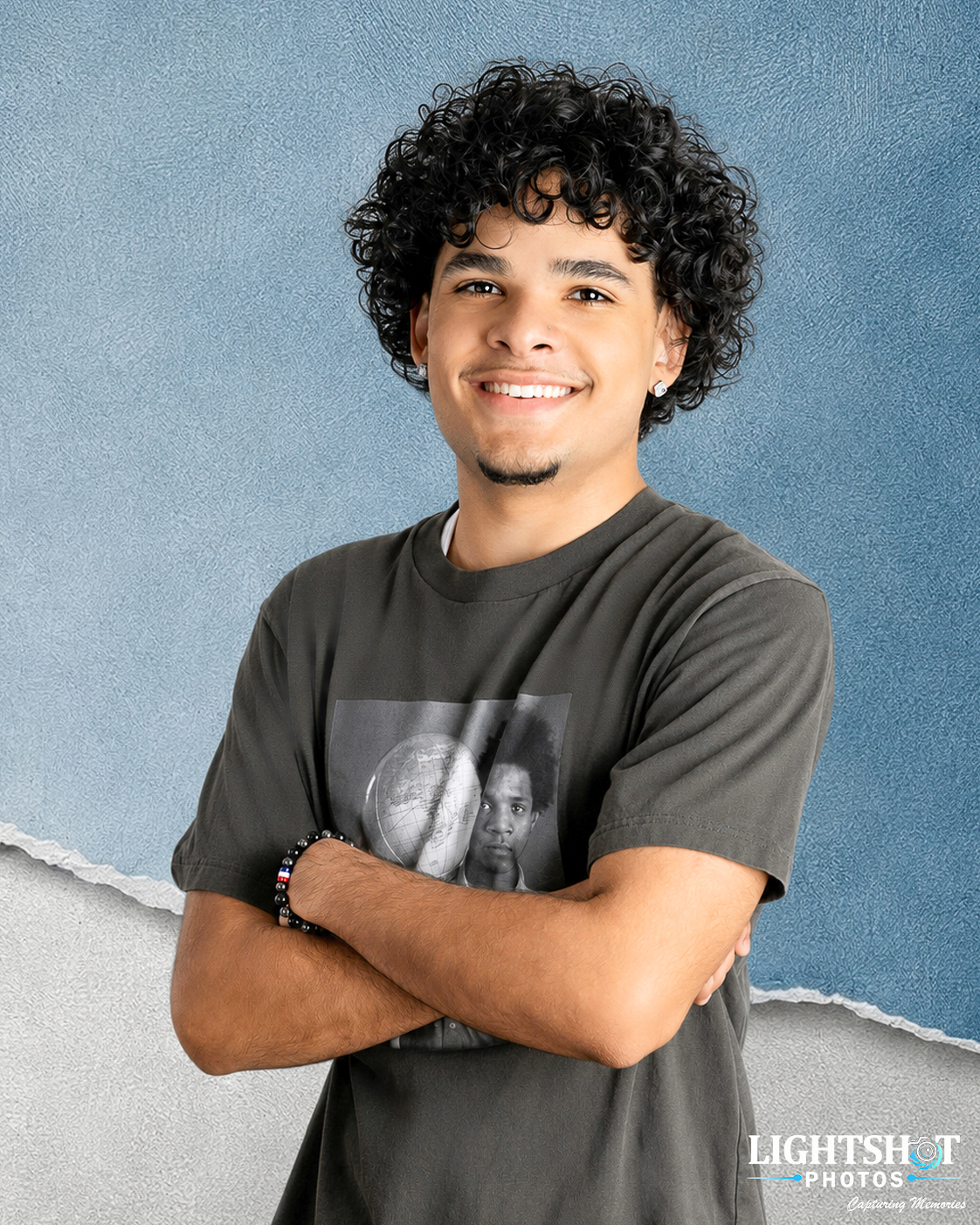 School portrait of a smiling student on a blue backdrop